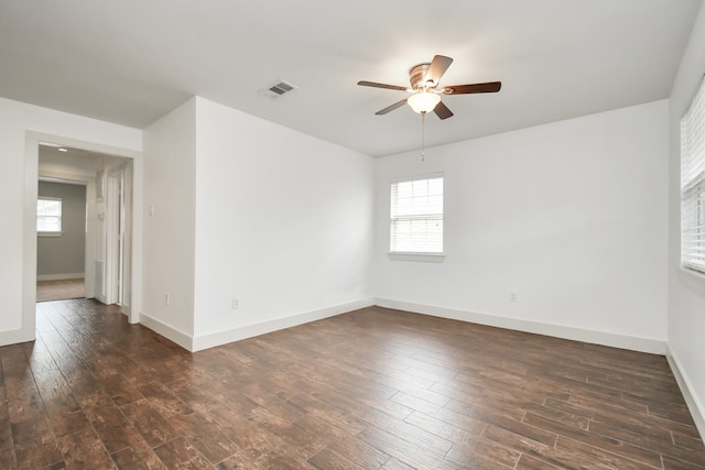 empty room featuring dark wood-type flooring and ceiling fan