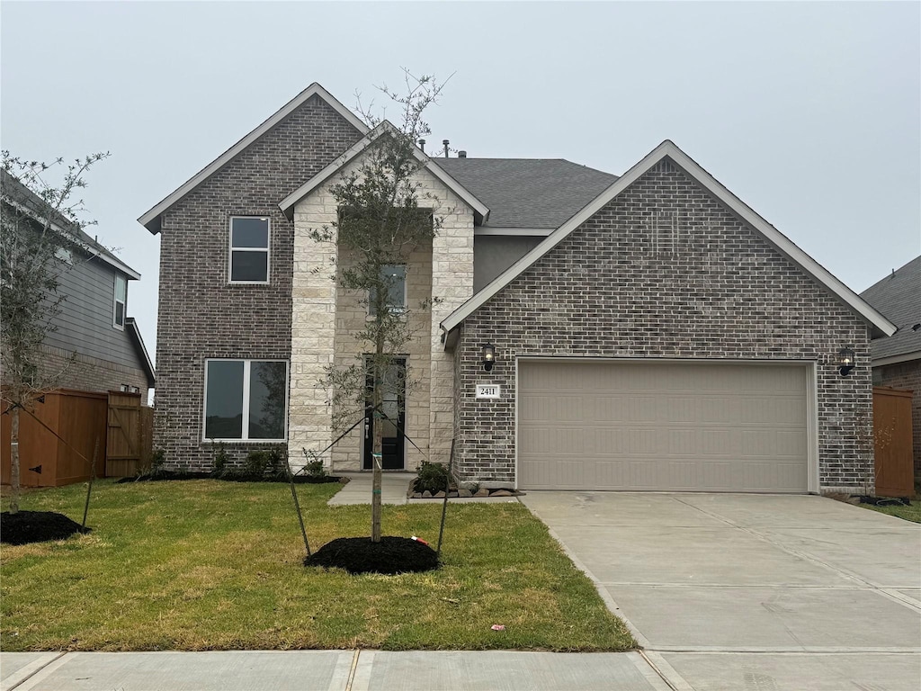 view of front of house with a front yard and a garage