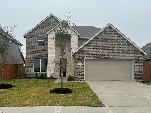 view of front of house with a front yard and a garage