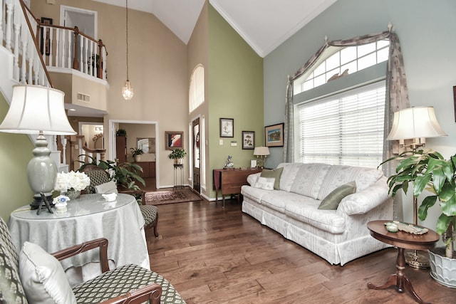 living room featuring crown molding, high vaulted ceiling, and dark hardwood / wood-style flooring