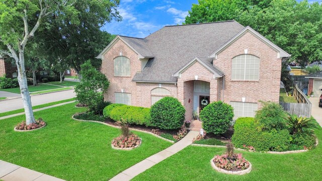 view of property featuring a front lawn