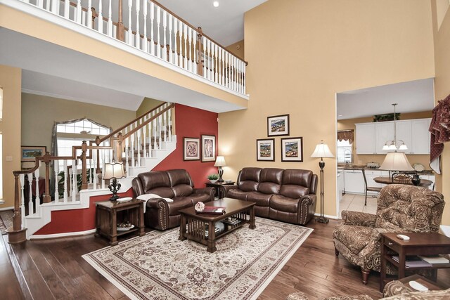 living room with a high ceiling and dark hardwood / wood-style floors