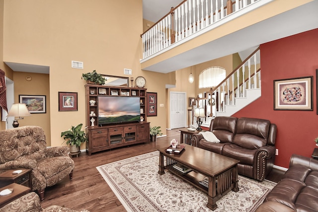 living room featuring hardwood / wood-style floors and a high ceiling