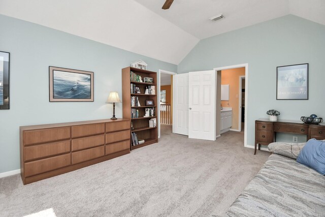 bedroom with lofted ceiling, ceiling fan, ensuite bathroom, and light carpet