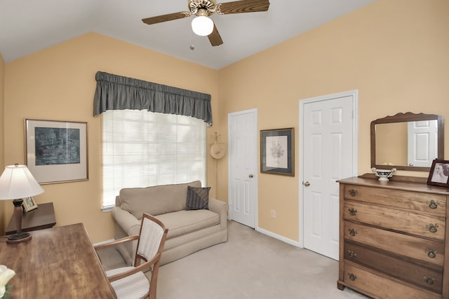 office area with light colored carpet, ceiling fan, and vaulted ceiling