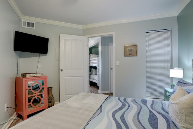 bedroom with hardwood / wood-style flooring and ornamental molding