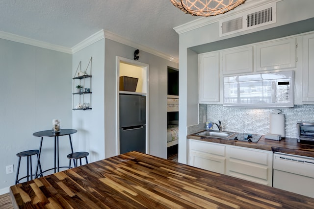 kitchen featuring stainless steel refrigerator, butcher block counters, wood-type flooring, and white cabinetry