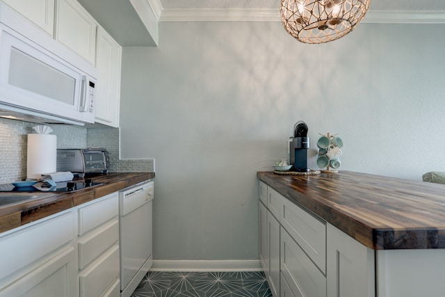 kitchen featuring butcher block countertops, white appliances, tasteful backsplash, tile patterned flooring, and crown molding