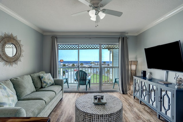 living room with crown molding, a textured ceiling, hardwood / wood-style flooring, and ceiling fan