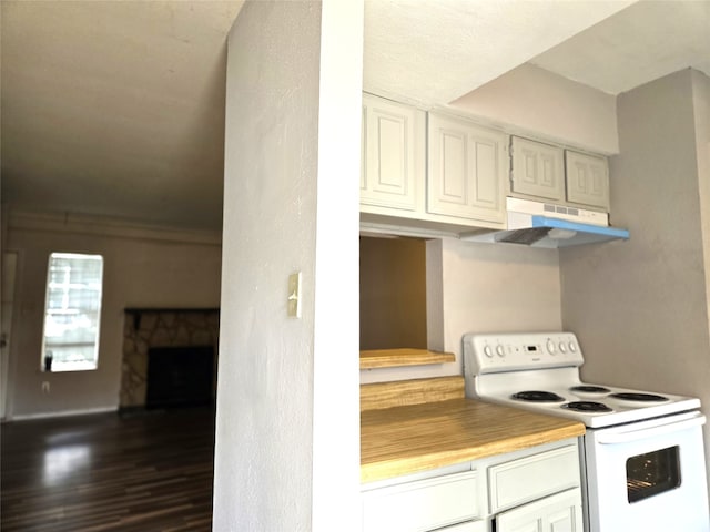 kitchen with white range with electric stovetop, dark hardwood / wood-style floors, white cabinetry, and a stone fireplace