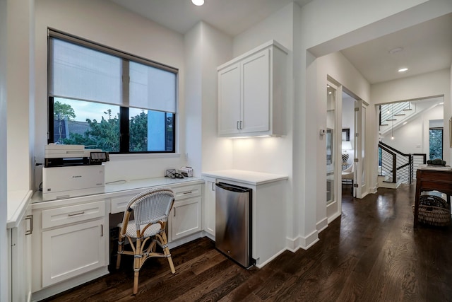 interior space featuring dark wood-type flooring and built in desk