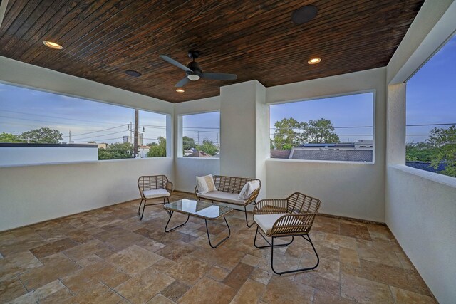 interior space with an outdoor living space and ceiling fan