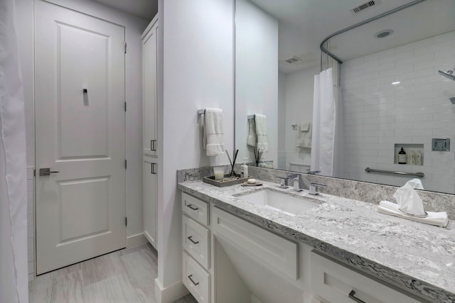 bathroom with vanity and curtained shower