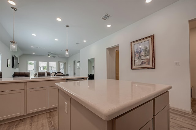 kitchen featuring visible vents, a kitchen island, open floor plan, light wood-type flooring, and recessed lighting