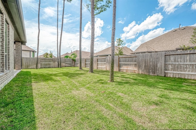 view of yard with a fenced backyard