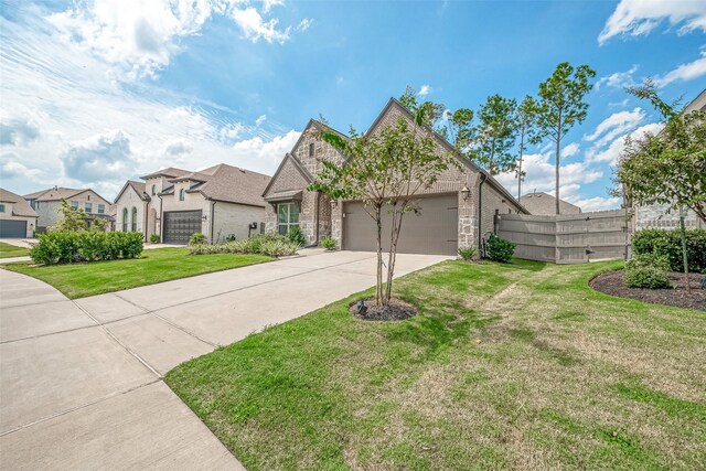 view of front of home with a garage and a front yard