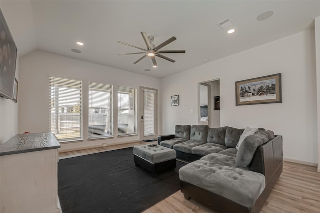 living room with vaulted ceiling, light wood-type flooring, visible vents, and recessed lighting