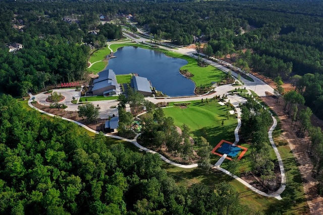 drone / aerial view featuring a forest view and a water view