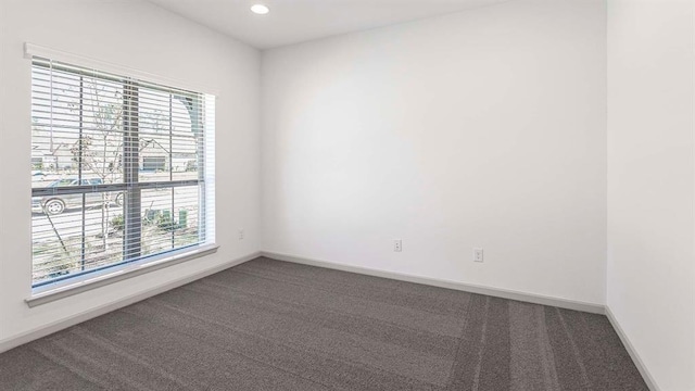 carpeted empty room with a wealth of natural light, baseboards, and recessed lighting