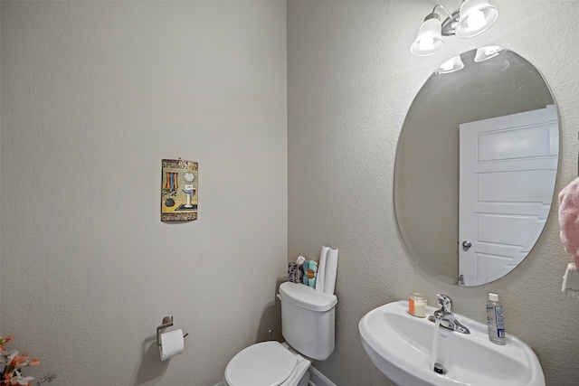 bathroom featuring toilet and sink