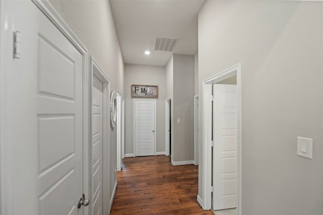 corridor with dark hardwood / wood-style flooring