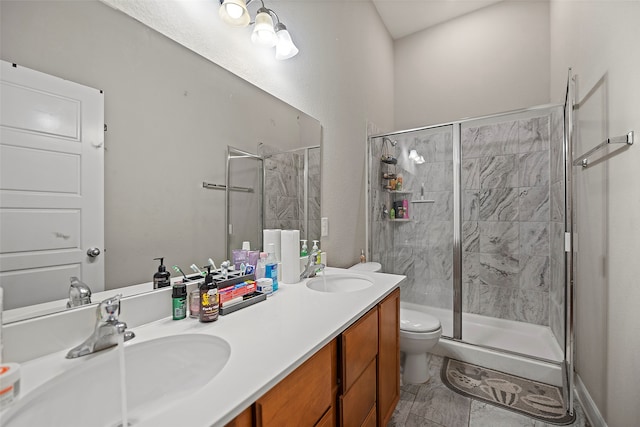 bathroom featuring vanity, toilet, and an enclosed shower