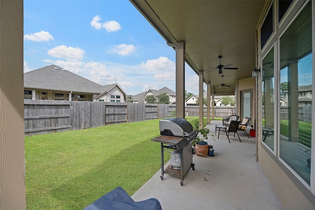 view of yard with ceiling fan and a patio