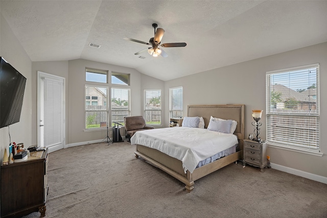 carpeted bedroom with lofted ceiling, ceiling fan, and a textured ceiling