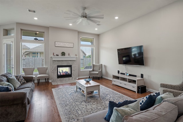 living room with a premium fireplace, ceiling fan, and hardwood / wood-style floors