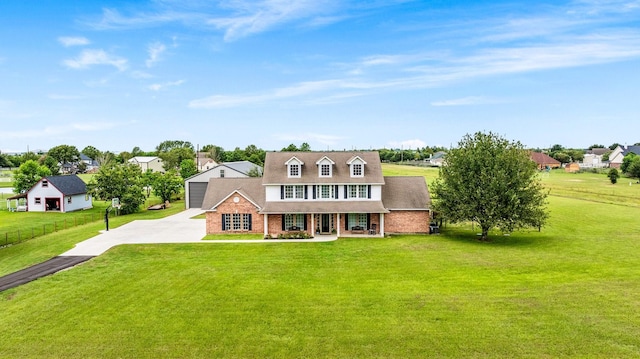 view of front of property with driveway, a front lawn, a porch, and fence