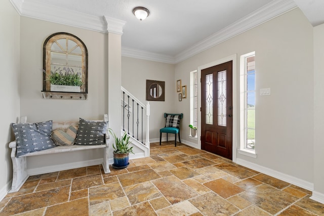 entrance foyer featuring crown molding, stairway, baseboards, and stone tile floors