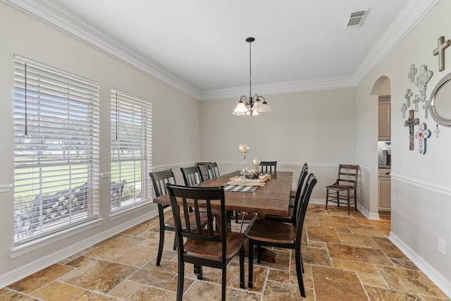 dining space with arched walkways, crown molding, stone tile flooring, visible vents, and baseboards