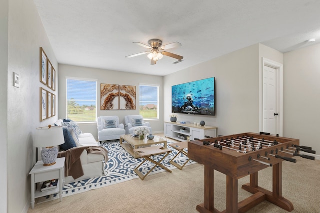 living room with a ceiling fan, carpet flooring, and baseboards