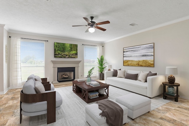 living area featuring a healthy amount of sunlight, visible vents, a textured ceiling, and ornamental molding