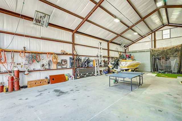 garage featuring a workshop area and metal wall