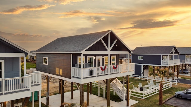 back house at dusk with a balcony