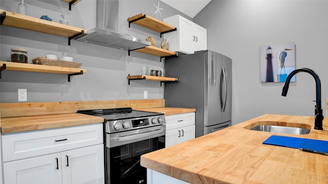 kitchen featuring white cabinets, stainless steel appliances, sink, island exhaust hood, and butcher block counters