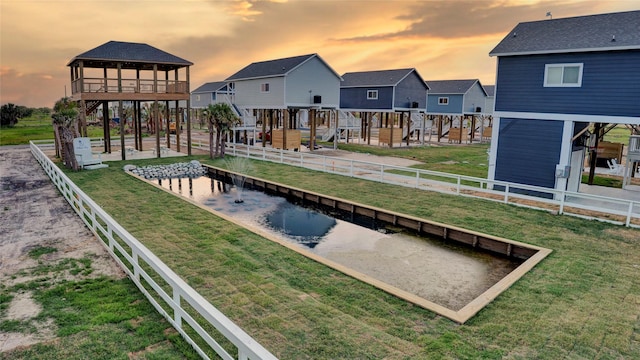 exterior space with fence private yard, a residential view, a yard, and a patio