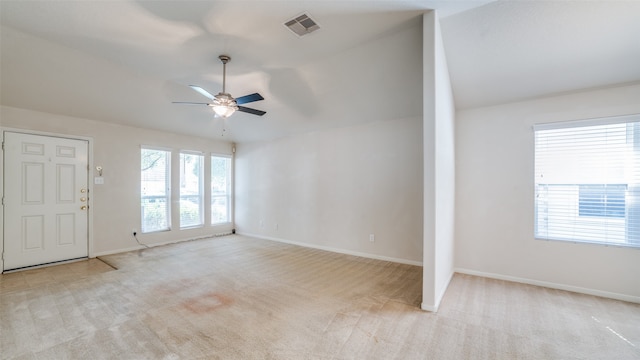 carpeted empty room featuring lofted ceiling and ceiling fan