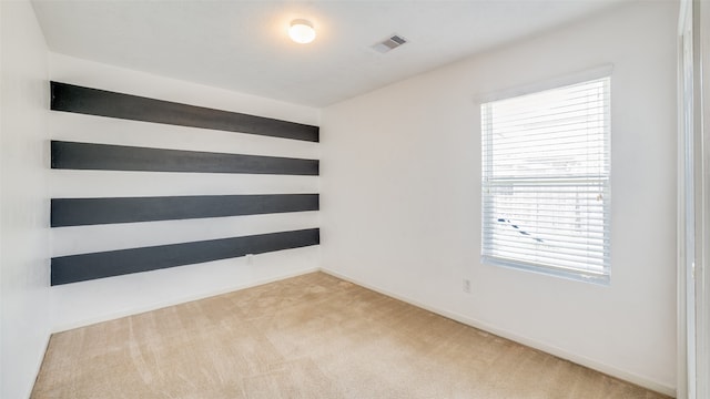 carpeted spare room with a wealth of natural light