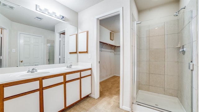 bathroom with vanity and a shower with shower door