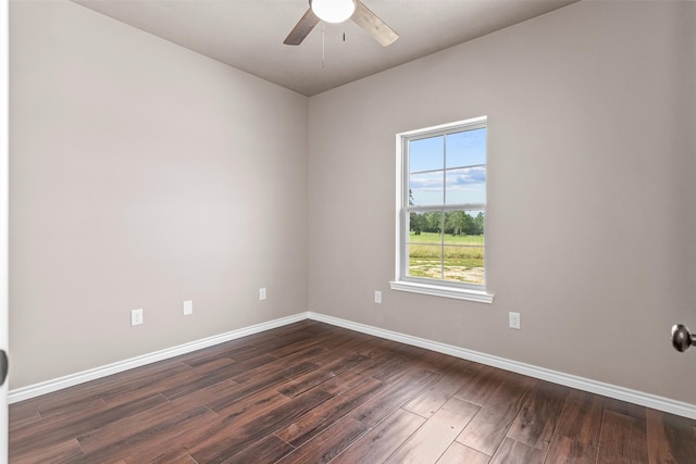 empty room featuring ceiling fan and dark hardwood / wood-style flooring