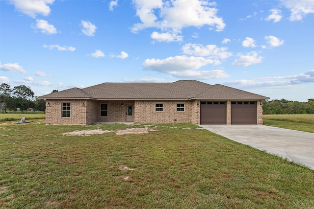 view of front of property featuring a garage and a front lawn