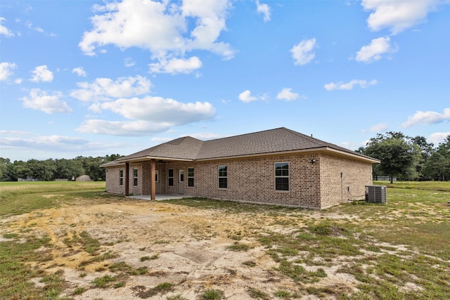 back of property with a patio area and central AC