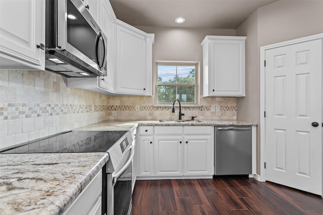 kitchen featuring light stone counters, stainless steel appliances, dark hardwood / wood-style flooring, white cabinetry, and sink