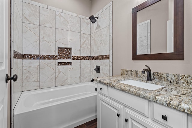 bathroom with vanity and tiled shower / bath