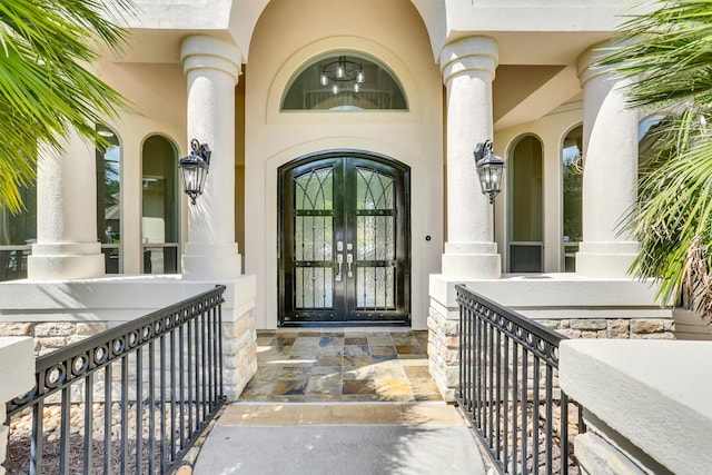 entrance to property with french doors and a porch