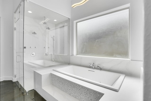 bathroom with shower with separate bathtub and a healthy amount of sunlight