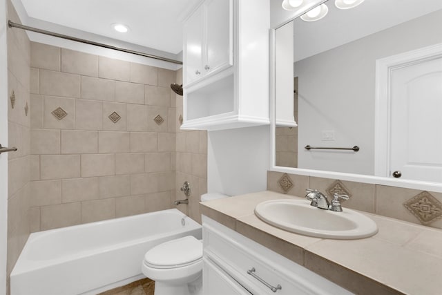 full bathroom with vanity, toilet, and tiled shower / bath combo