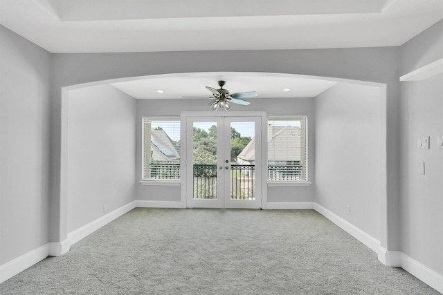 unfurnished room featuring light carpet, french doors, and ceiling fan